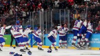 Jack Hughes (86) of the United States is congratulated by teammates after scoring the winning goal against Canada in the men's ice hockey gold medal game during the Milano Cortina 2026 Olympic Winter Games at Milano Santagiulia Ice Hockey Arena.