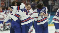 Team USA players celebrate after a golden goal in overtime by Jack Hughes #86 of Team United States during the Milano Cortina 2026 Olympic Winter Games at Milano Santagiulia Ice Hockey Arena.