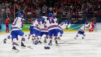 United States bench react after the game-winning goal is scored by Jack Hughes (not pictured) of the United States against Canada in the men's ice hockey gold medal game during the Milano Cortina 2026 Olympic Winter Games at Milano Santagiulia Ice Hockey Arena.