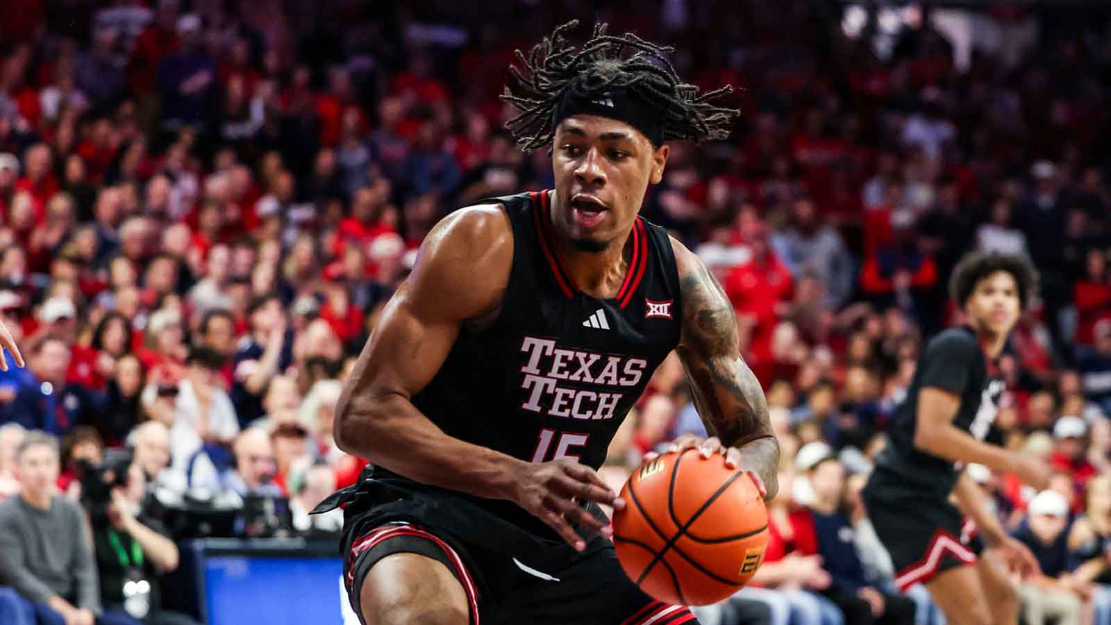 Texas Tech Red Raiders forward JT Toppin (15) dribbles and dunks the ball during the first half of the game against the Arizona Wildcats at McKale Memorial Center.