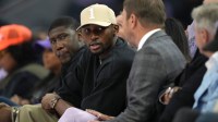 Golden State Warriors forward Jonathan Kuminga (center left) talks with owner Joe Lacob (center right) during the second quarter of the game between the Golden State Valkyries and the Los Angeles Sparks at Chase Center.