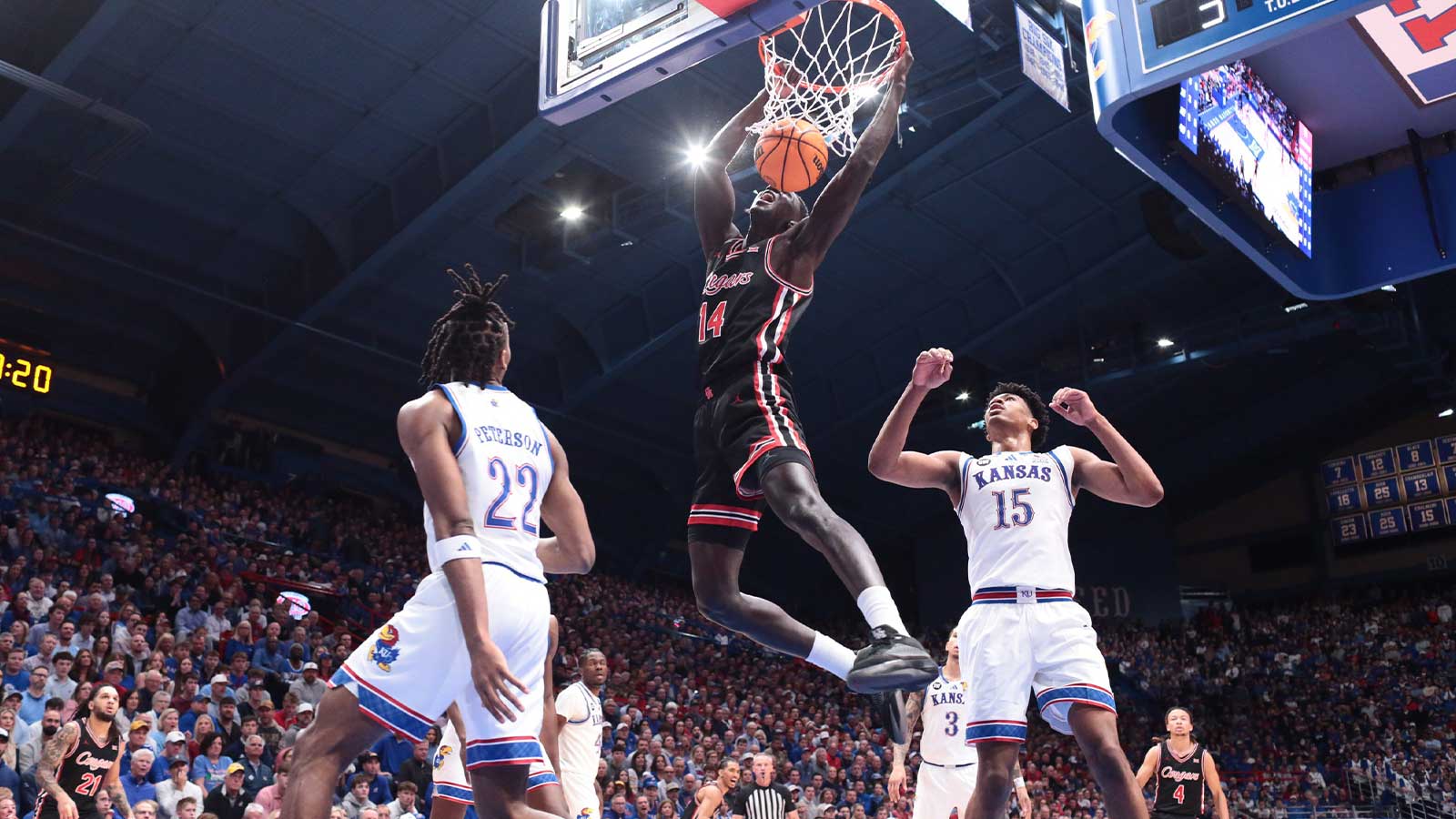 Houston Cougars forward Kalifa Sakho (14) dunks the ball against Kansas Jayhawks during the game inside Allen Fieldhouse on Monday, Feb. 23, 2026.