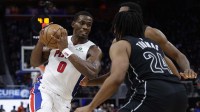 Detroit Pistons center Jalen Duren (0) dribbles defended by Brooklyn Nets guard Cam Thomas (24) in the second half at Little Caesars Arena.