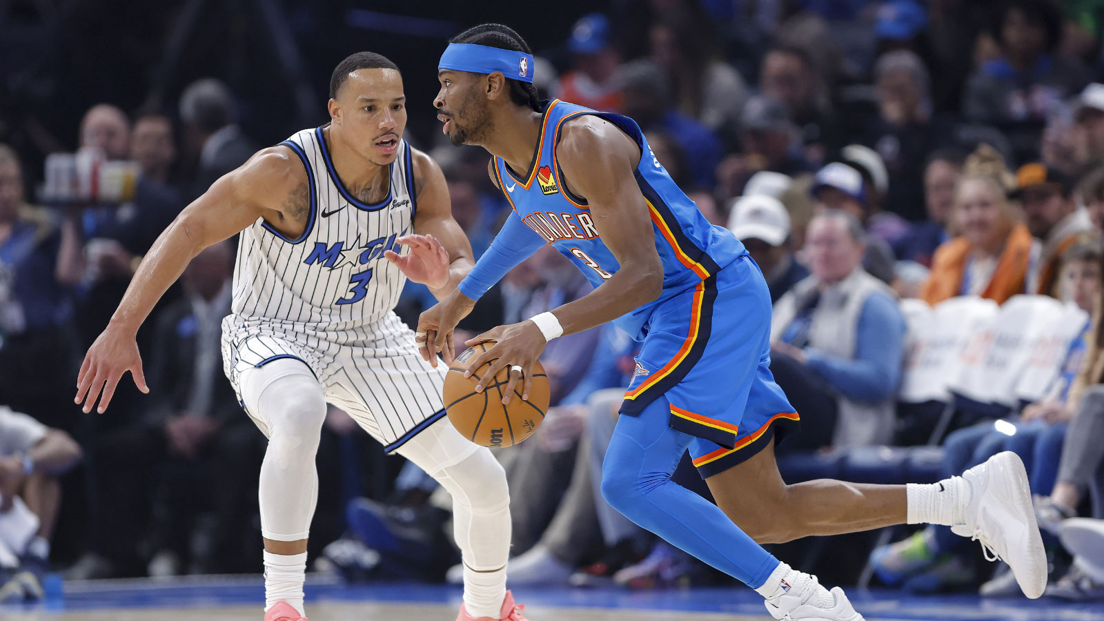 Thunder guard Shai Gilgeous-Alexander (2) drives past Orlando Magic guard Desmond Bane (3) during the first quarter at Paycom Center