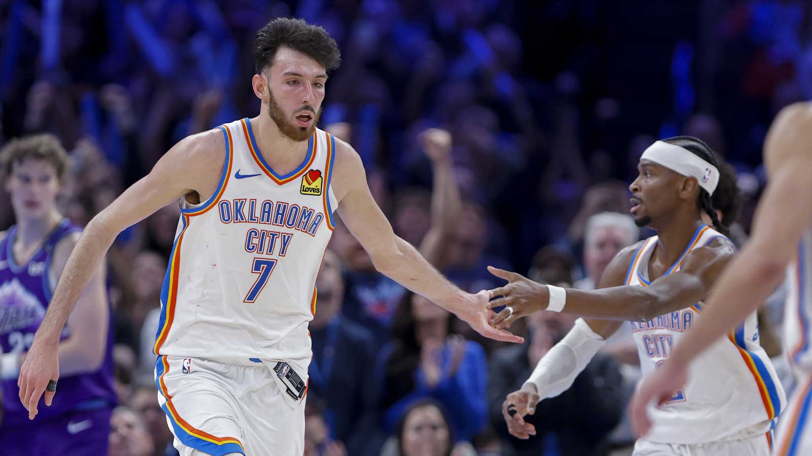 Thunder center/forward Chet Holmgren (7) and Oklahoma City Thunder guard Shai Gilgeous-Alexander (2) celebrate after a basket during overtime against the Utah Jazz at Paycom Center