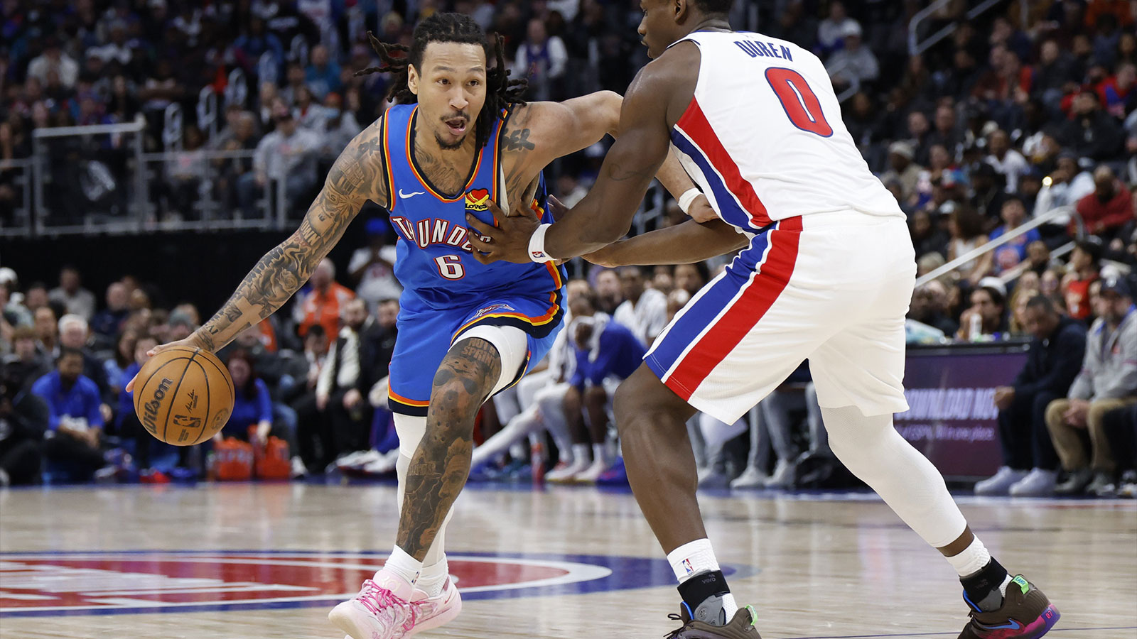 Thunder forward Jaylin Williams (6) dribbles defended by Detroit Pistons center Jalen Duren (0) in the second half at Little Caesars Arena