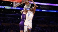 Thunder guard Jalen Williams (8) dunks the ball over Los Angeles Lakers guard Austin Reaves (15) during the first half at Crypto.com Arena