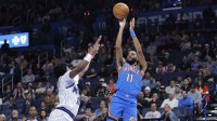 Thunder guard Isaiah Joe (11) shoots against the Orlando Magic during the second half at Paycom Center with Thunder's Kenrich Williams and Magic's Paolo Banchero in the background