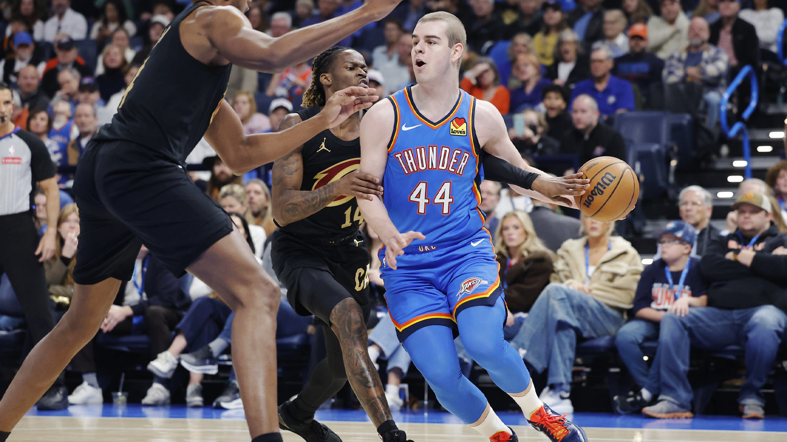 Thunder guard Nikola Topić (44) drives past Cleveland Cavaliers guard Keon Ellis (14) during the first half at Paycom Center