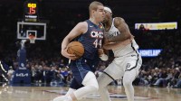 Thunder guard Nikola Topić (44) drives past Brooklyn Nets guard/forward Terance Mann (14) during the second half at Paycom Center with Thunder head coach Mark Daigneault in the background