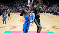 San Antonio Spurs guard Stephon Castle (5) drives to the basket against Oklahoma City Thunder forward Jaylin Williams (6) during the second half at Frost Bank Center.