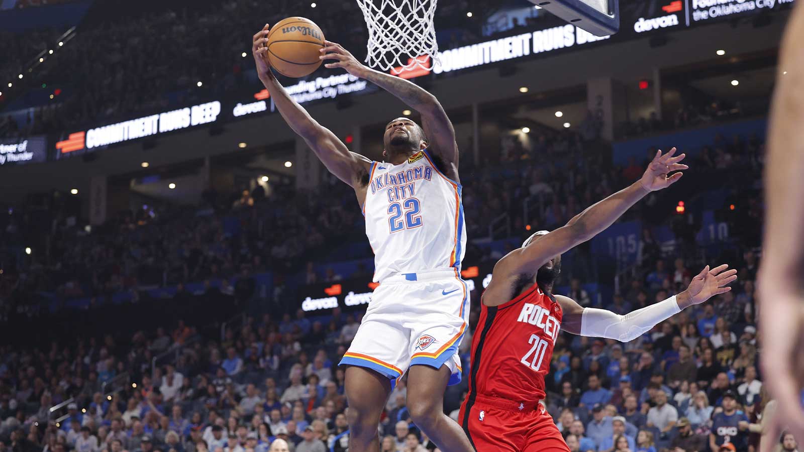 Thunder guard Cason Wallace (22) goes up for a basket beside Houston Rockets guard Josh Okogie (20) during the first half at Paycom Center