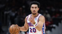76ers guard Jared McCain (20) dribbles and signals to teammates during the game against the Atlanta Hawks in the first quarter at State Farm Arena