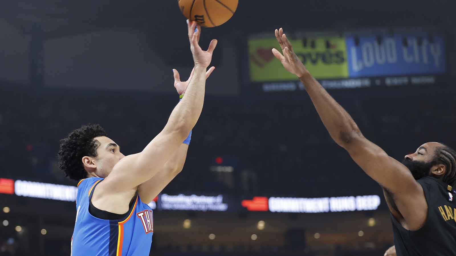 Thunder guard Jared McCain (3) shoots a three point basket as Cleveland Cavaliers guard James Harden (1) defends during the first half at Paycom Center
