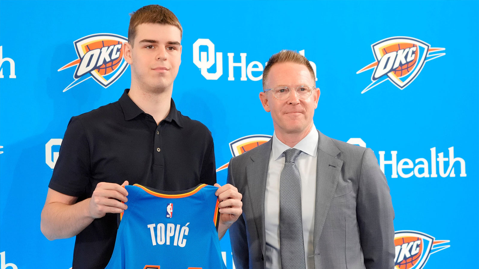 Nikola Topic stands with Thunder general manager Sam Presti during an introductory press conference for the 2024 Thunder draft picks at Oklahoma Contemporary Arts Center in Oklahoma City