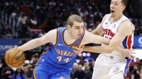 Thunder guard Nikola Topic (44) dribbles defended by Detroit Pistons forward Duncan Robinson (55) in the second half at Little Caesars Arena with Nuggets' Nikola Jokic in the background