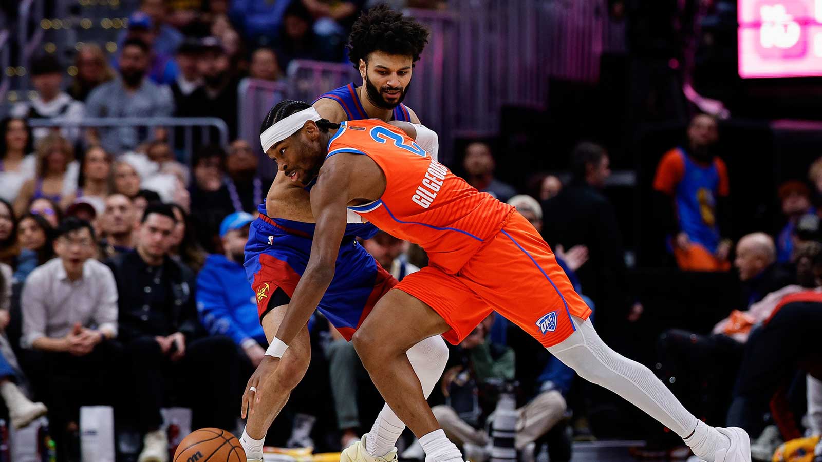 Thunder guard Shai Gilgeous-Alexander (2) controls the ball under pressure from Denver Nuggets guard Jamal Murray (27) in the fourth quarter at Ball Arena