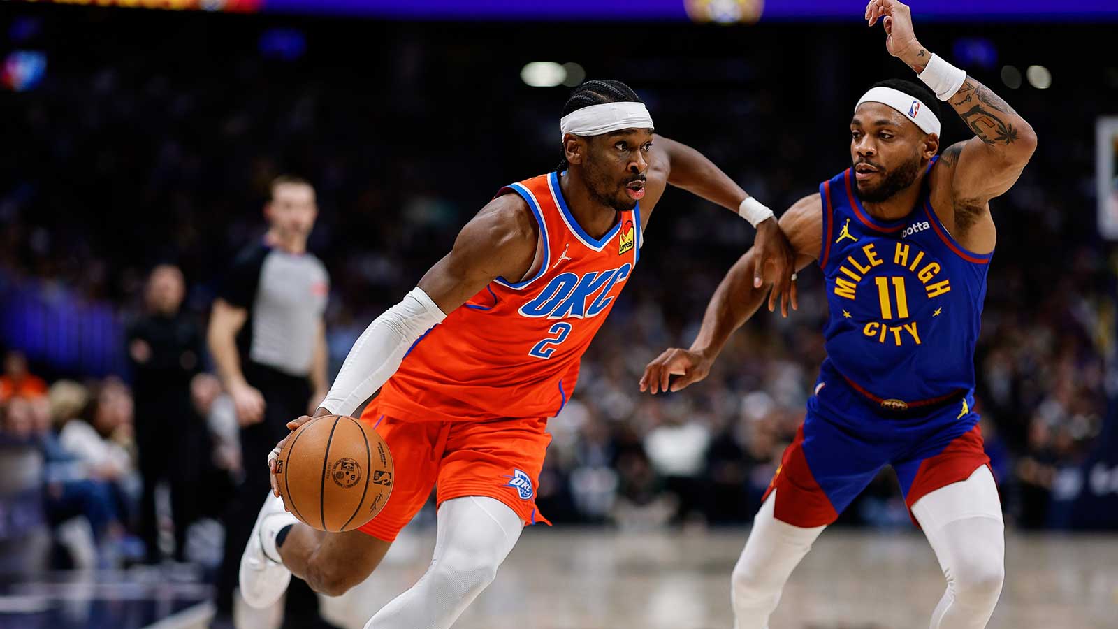 Thunder guard Shai Gilgeous-Alexander (2) controls the ball as Denver Nuggets guard Bruce Brown (11) guards in the second quarter at Ball Arena