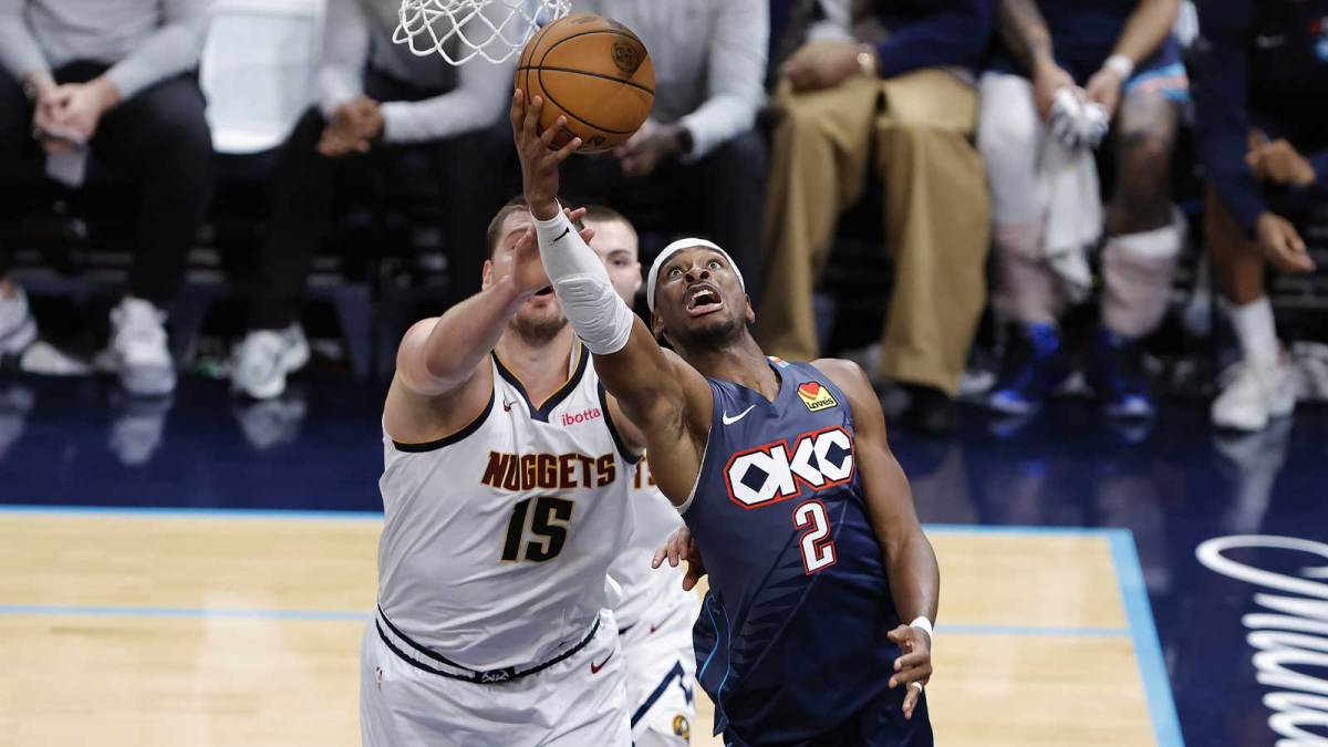 Thunder guard Shai Gilgeous-Alexander (2) goes up for a basket in front of Denver Nuggets center Nikola Jokić (15) during the fourth quarter at Paycom Center with Thunder's Mark Daigneault in the background