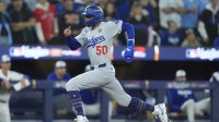 Los Angeles Dodgers shortstop Mookie Betts (50) runs home to score on a sacrifice fly by second baseman Tommy Edman (not pictured) in the sixth inning against the Toronto Blue Jays during game seven of the 2025 MLB World Series at Rogers Centre.
