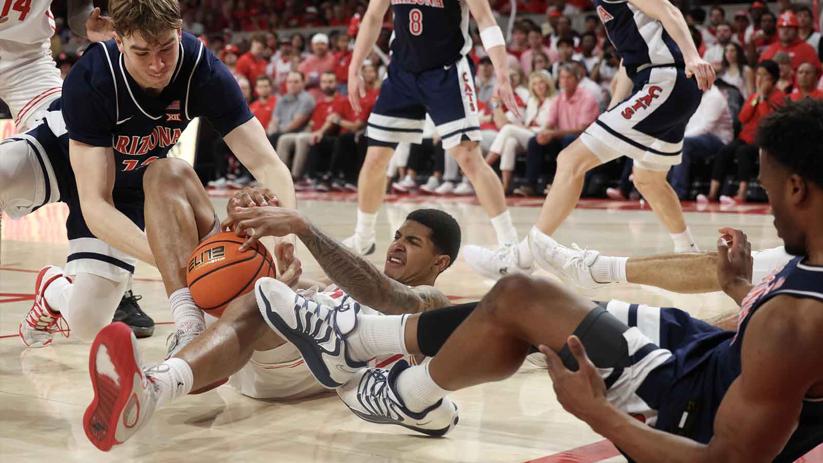Arizona Wildcats center Motiejus Krivas (13) and Houston Cougars center Chris Cenac Jr. (5) fight over the ball in the second half at Fertitta Center.