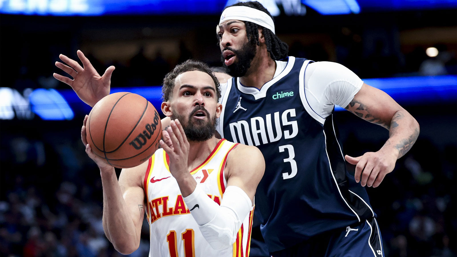 Atlanta Hawks guard Trae Young (11) looks to pass as Dallas Mavericks forward Anthony Davis (3) defends during the fourth quarter at American Airlines Center.