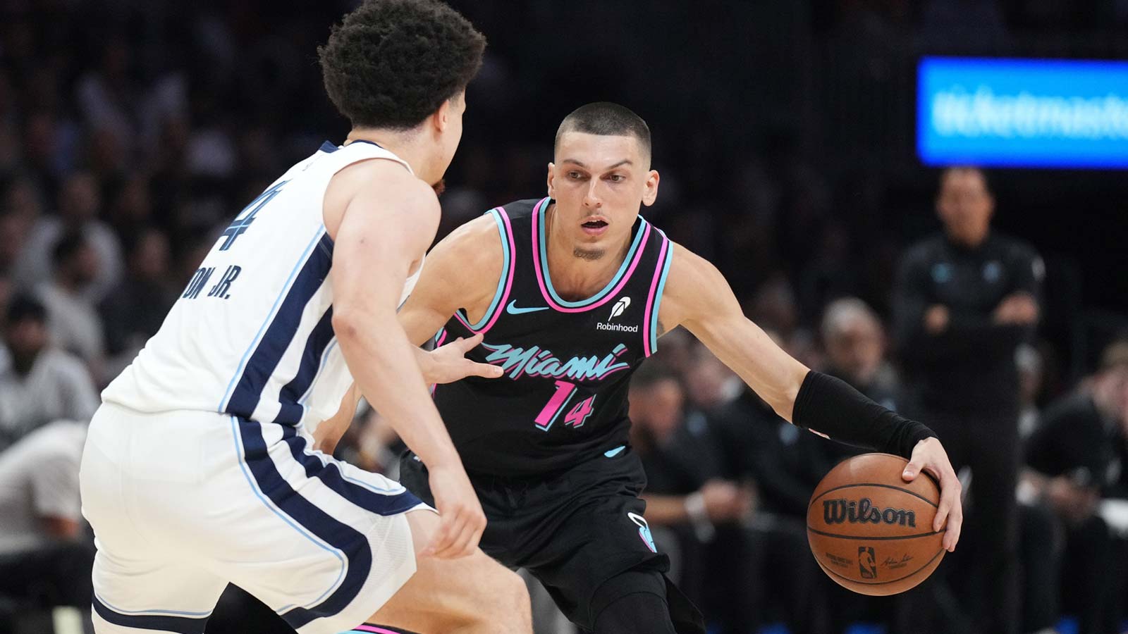 Miami Heat guard Tyler Herro (14) looks to drive past Memphis Grizzlies guard Walter Clayton Jr. (4) during the second half at Kaseya Center.