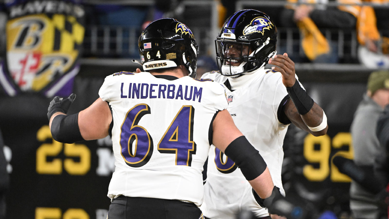 Baltimore Ravens center Tyler Linderbaum (64) and Baltimore Ravens quarterback Lamar Jackson (8) react before the game at Acrisure Stadium.