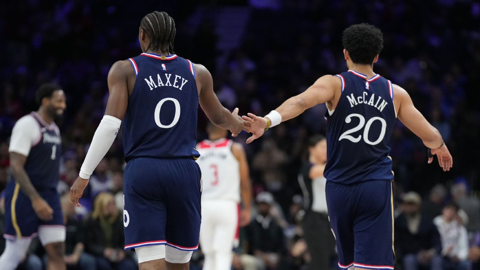 Philadelphia 76ers guard Tyrese Maxey (0) reacts with guard Jared McCain (20) against the Washington Wizards in the second quarter at Xfinity Mobile Arena.