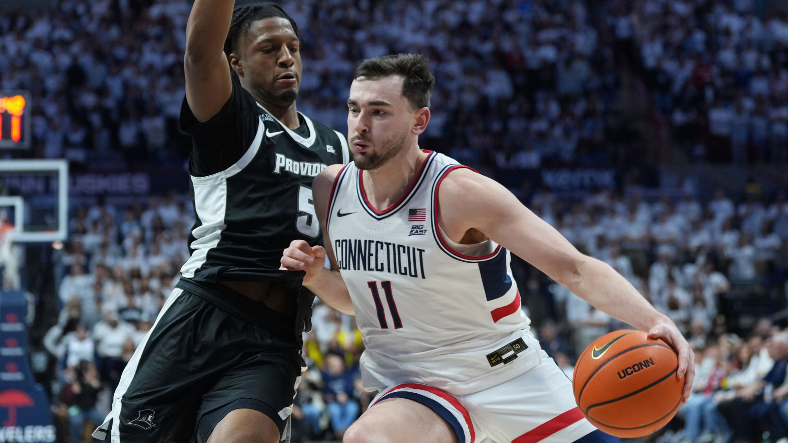 UConn Huskies forward Alex Karaban (11) drives the ball against Providence Friars forward Jamier Jones (5) in the second half at Harry A. Gampel Pavilion