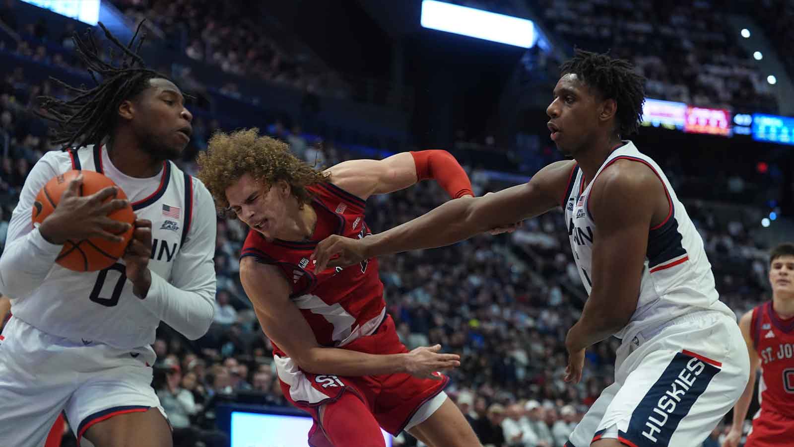 UConn Huskies forward Tarris Reed Jr. (5) and guard Malachi Smith (0) work for the ball against St. John's Red Storm forward Rubén Prey (17) in the second half at PeoplesBank Arena.
