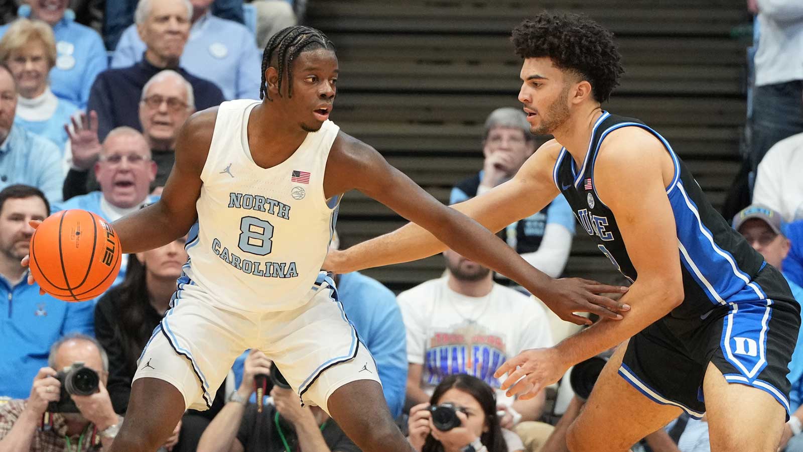North Carolina Tar Heels forward Caleb Wilson (8) with the ball as Duke Blue Devils forward Cameron Boozer (12) defends in the first half at Dean E. Smith Center.