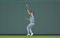 Texas Rangers center fielder Evan Carter (32) catches a fly ball in the sixth inning against the Kansas City Royals at Kauffman Stadium.