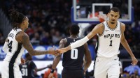 San Antonio Spurs forward Victor Wembanyama (1) receives congratulations from guard Devin Vassell (24) in the second half against the Detroit Pistons at Little Caesars Arena.