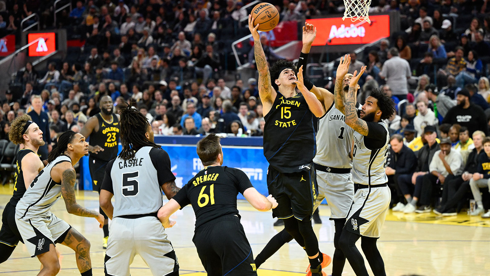 Golden State Warriors forward Gui Santos (15) shoots against San Antonio Spurs forward Victor Wembanyama (1) and forward Julian Champagnie (30) in the third quarter at Chase Center.