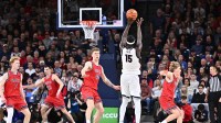 Gonzaga Bulldogs forward Graham Ike (15) makes a three-point basket against Saint Mary's Gaels center Andrew McKeever (45) in the second half at McCarthey Athletic Center. Gonzaga Bulldogs won 73-65. Mandatory Credit: James Snook-Imagn Images