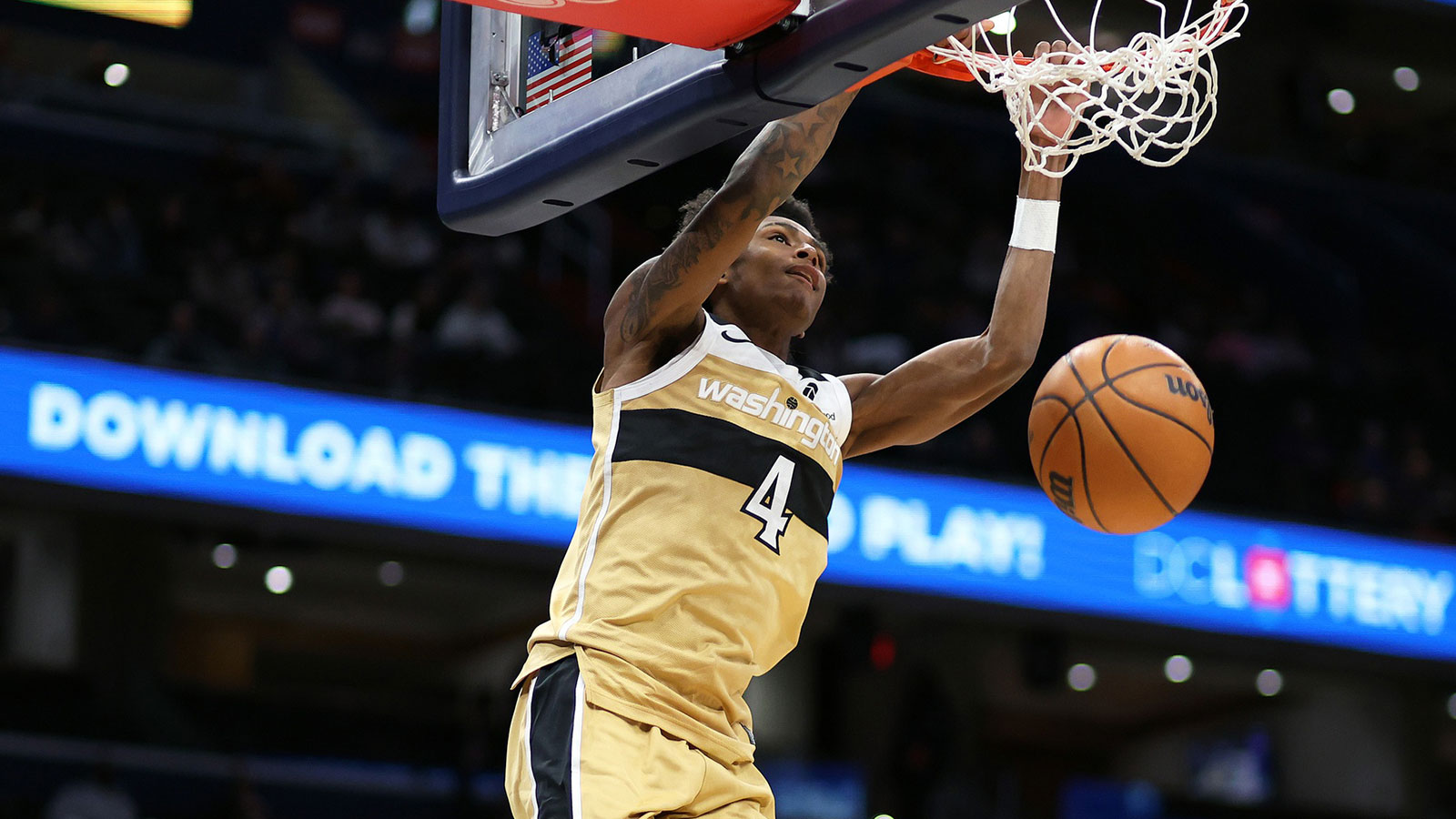Washington Wizards guard AJ Johnson (4) dunks during the first half against the Sacramento Kings at Capital One Arena.