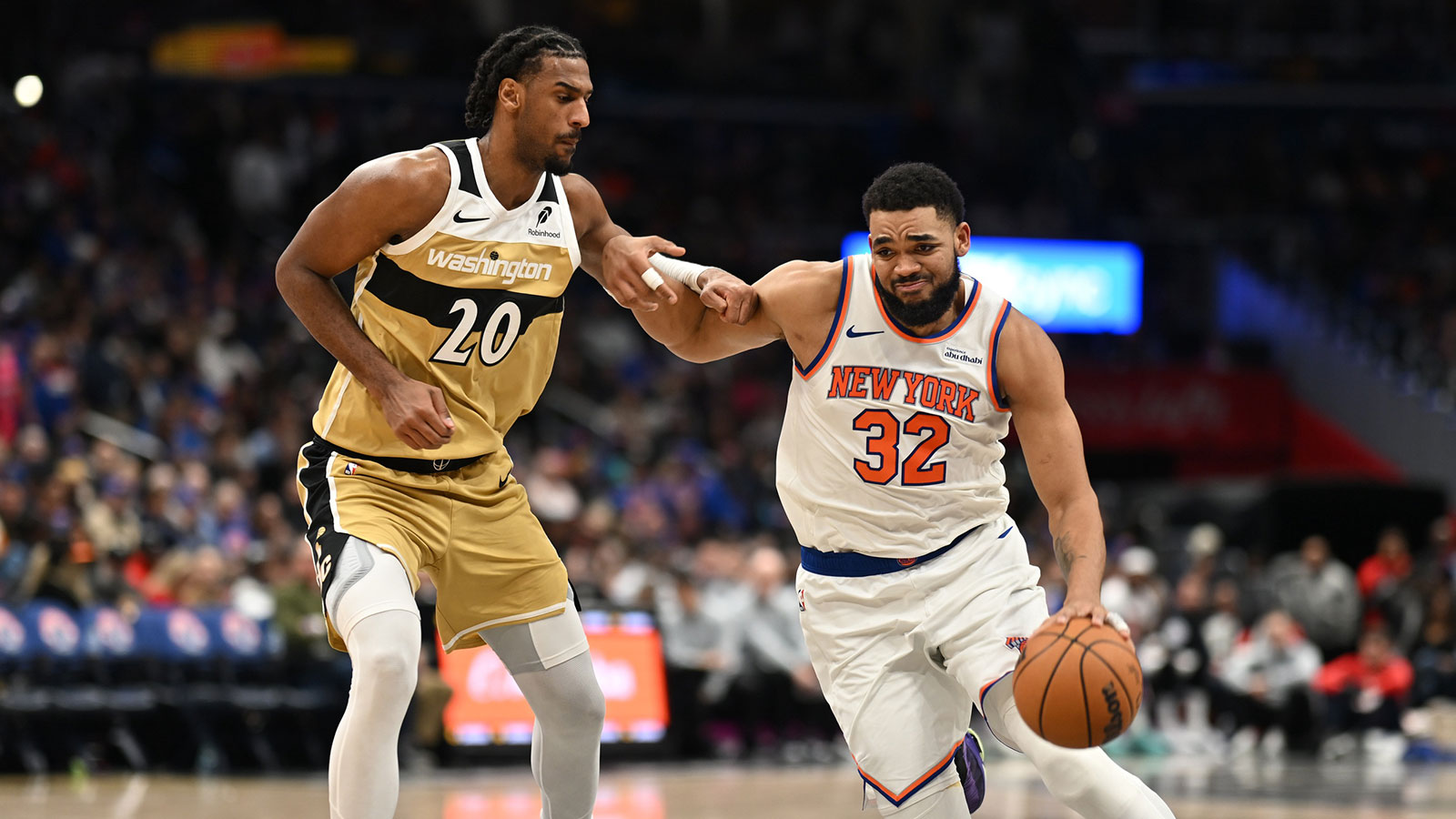New York Knicks center Karl-Anthony Towns (32) dribbles the ball in front of Washington Wizards center Alex Sarr (20) during the third quarter at Capital One Arena. 