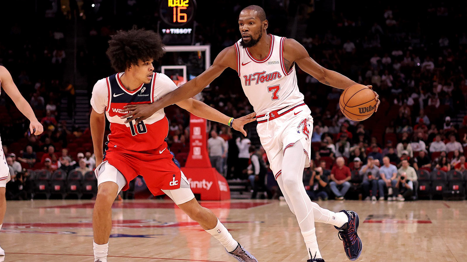 Houston Rockets forward Kevin Durant (7) handles the ball against Washington Wizards forward Kyshawn George (18) during the first quarter at Toyota Center. 