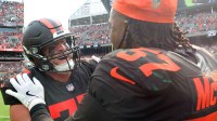 Cleveland Browns guard Wyatt Teller (77) celebrates with defensive end Isaiah McGuire (57) after beating the Green Bay Packers in an NFL football game at Huntington Bank Field, Sept. 21, 2025, in Cleveland, Ohio.