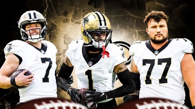 Alontae Taylor, Taysom Hill, Dillon Radunz all beside each other, New Orleans Saints wallpaper in the background