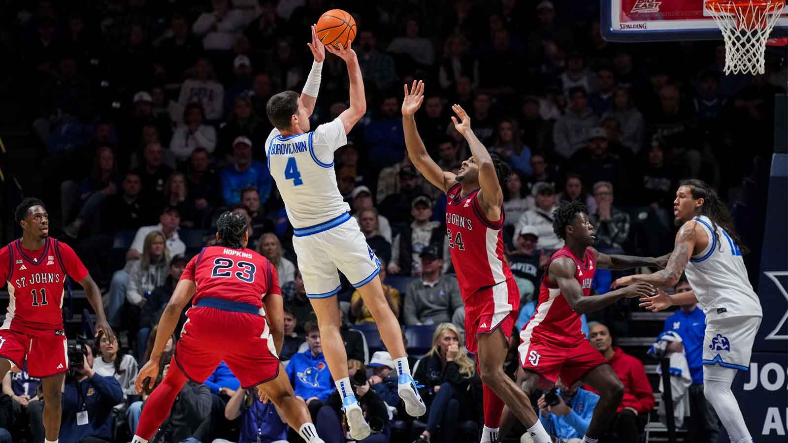 Xavier Musketeers forward Filip Borovicanin (4) shoots against St. John's Red Storm forward Zuby Ejiofor (24) in the second half at the Cintas Center. Mandatory Credit: Aaron