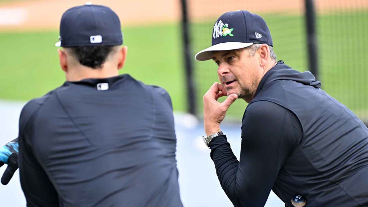 New York Yankees manager Aaron Boone (17) talks with outfielder Giancarlo Stanton (27) during spring training at George M. Steinbrenner Field.