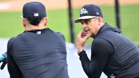New York Yankees manager Aaron Boone (17) talks with outfielder Giancarlo Stanton (27) during spring training at George M. Steinbrenner Field.