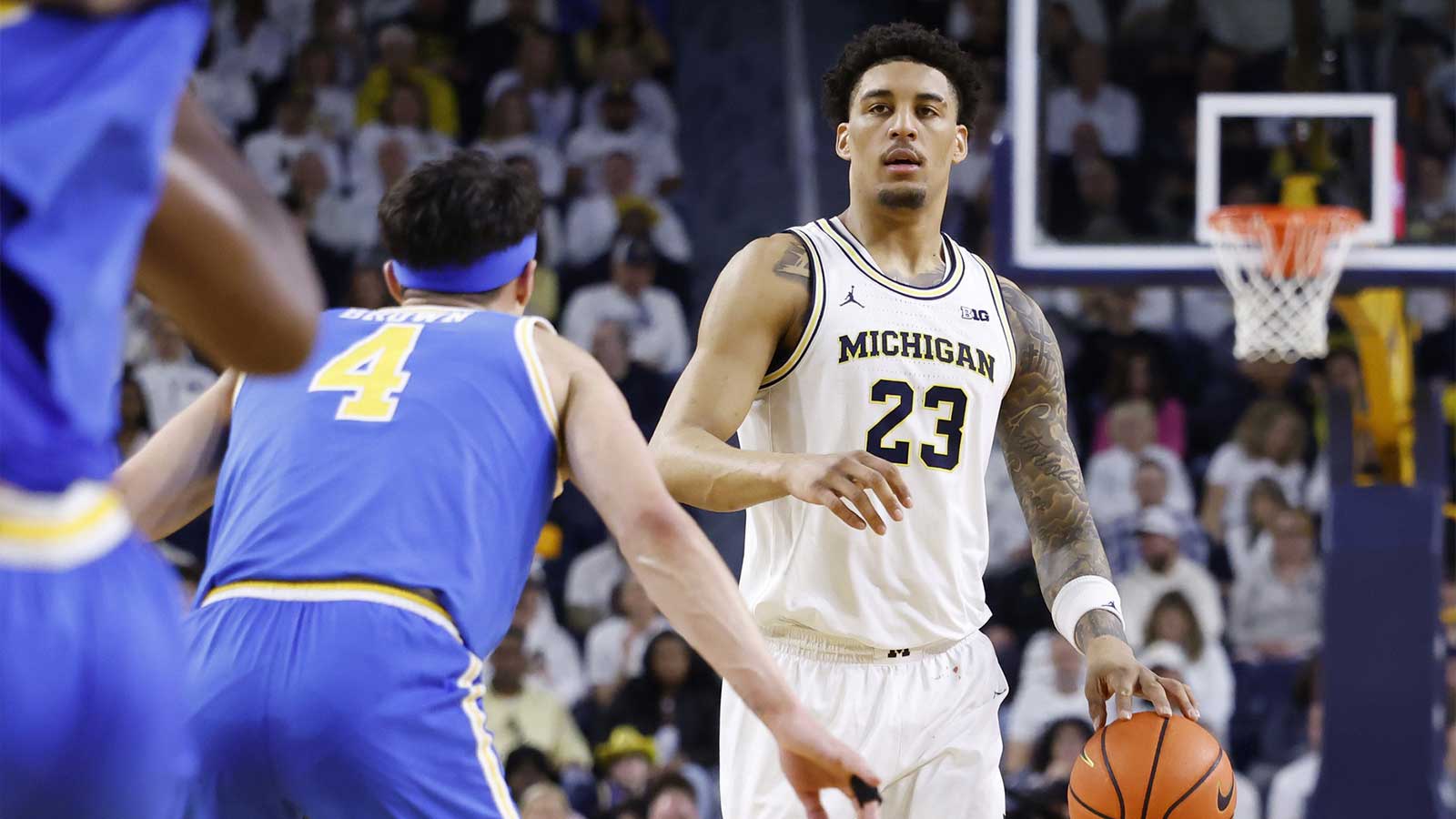 Michigan Wolverines forward Yaxel Lendeborg (23) is defended by UCLA Bruins guard Jamar Brown (4) in the first half at Crisler Center.