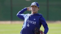 Los Angeles Dodgers pitcher Yoshinobu Yamamoto (18) throws during spring training camp.
