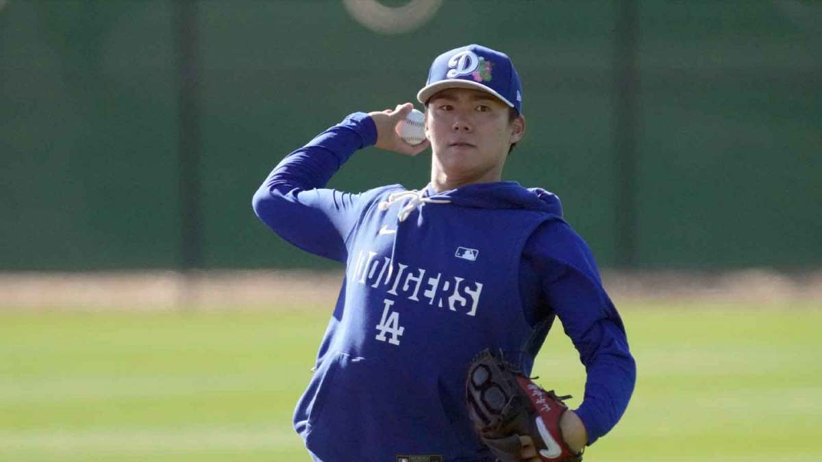 Los Angeles Dodgers pitcher Yoshinobu Yamamoto (18) throws during spring training camp.
