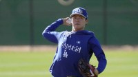 Los Angeles Dodgers pitcher Yoshinobu Yamamoto (18) throws during spring training camp.