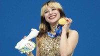 Alysa Liu of the United States celebrates with the gold medal in the women's free skate during the Milano Cortina 2026 Olympic Winter Games at Milano Ice Skating Arena.