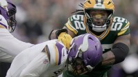 Minnesota Vikings' J.J. McCarthy (9) evades a sack by Green Bay Packers defensive end Rashan Gary (52) during the fourth quarter of their game Sunday, November 23, 2025 at Lambeau Field in Green Bay, Wisconsin. The Green Bay Packers beat the Minnesota Vikings 23-6.